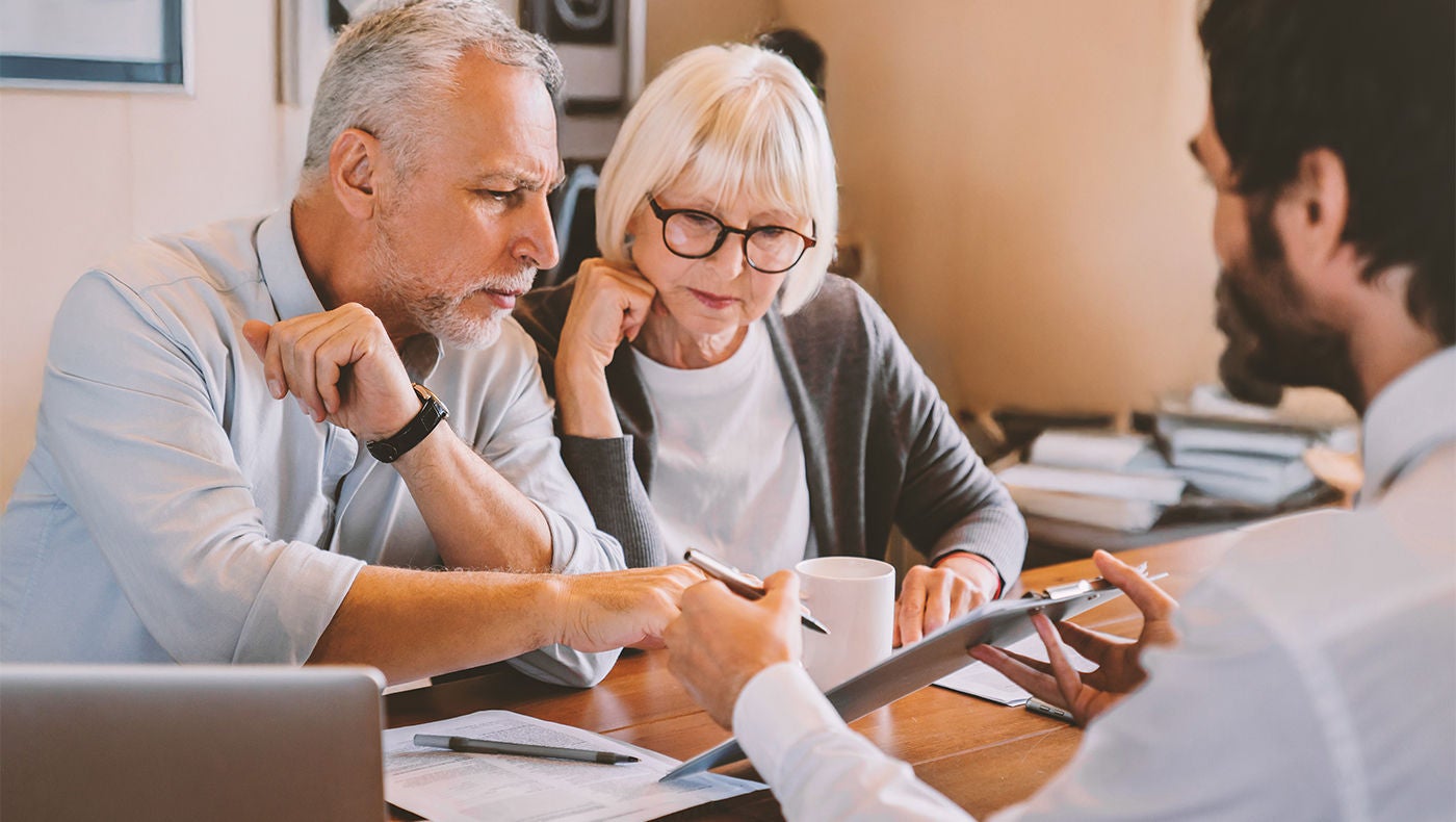 Doctor explaining a couple about prostate cancer treatments
