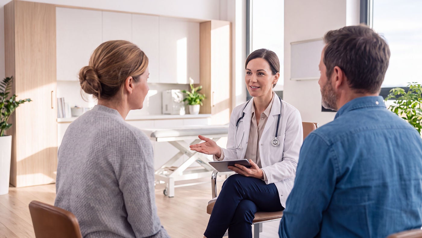  female doctor talking to couple