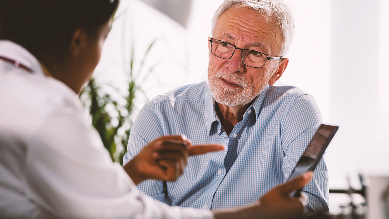 A physician explains benign prostate enlargement to a male patient