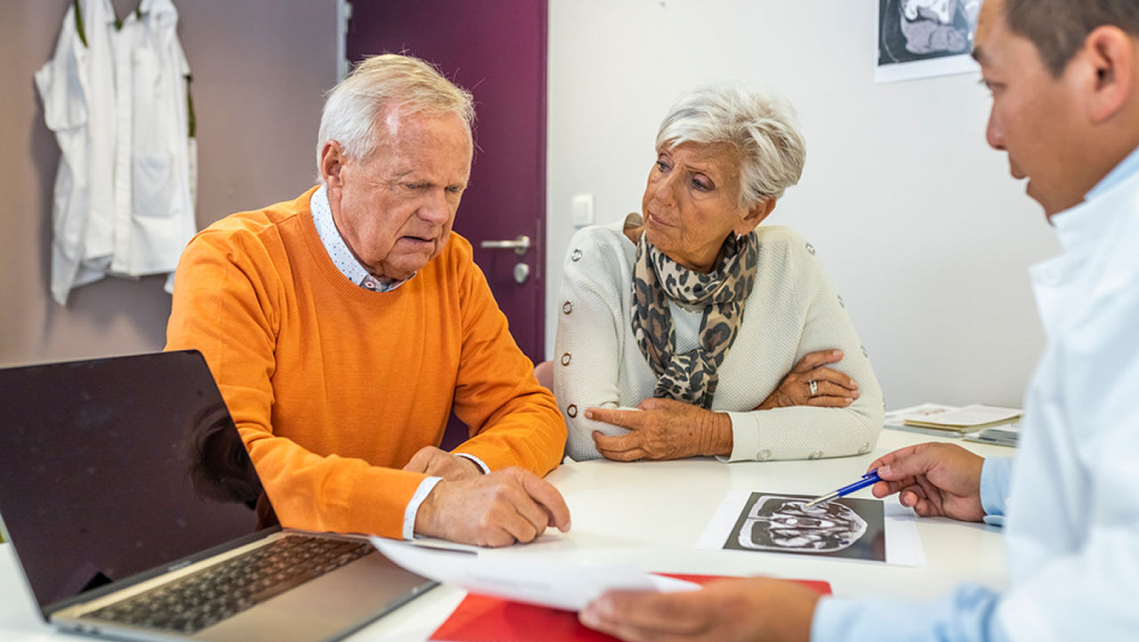 A physician explains unrinary incontinance to her elderly patients