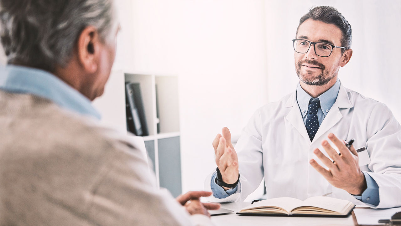 Man talking to doctor about prostate cancer treatments