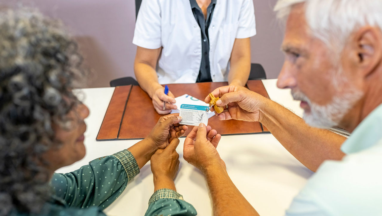 A physician explains unrinary incontinance to her elderly patients