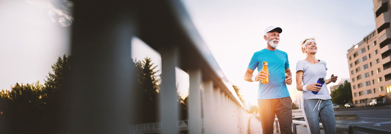 Man suffering from male incontinence and woman running down the street