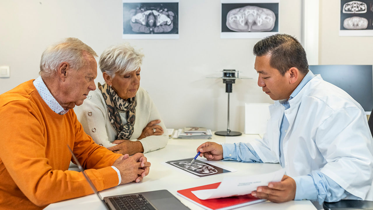 A physician explains unrinary incontinance to her elderly patients